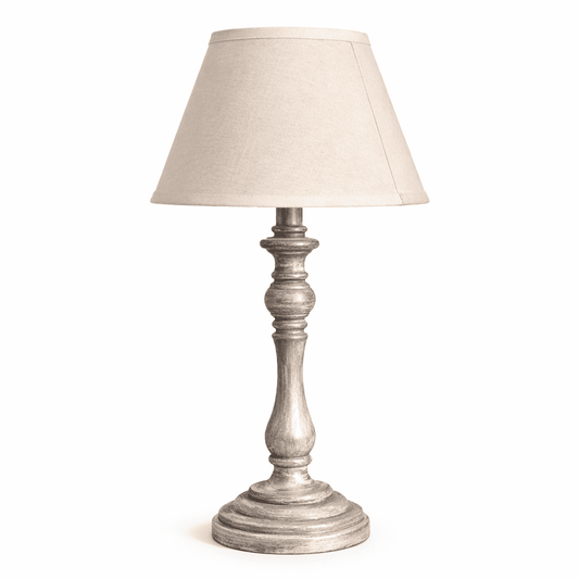 Table lamp with a textured base and beige shade on a white background