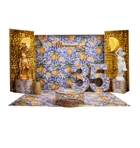 Decorative birthday setup with statues, lemons, and a colorful backdrop lemon amalfi themed for hire