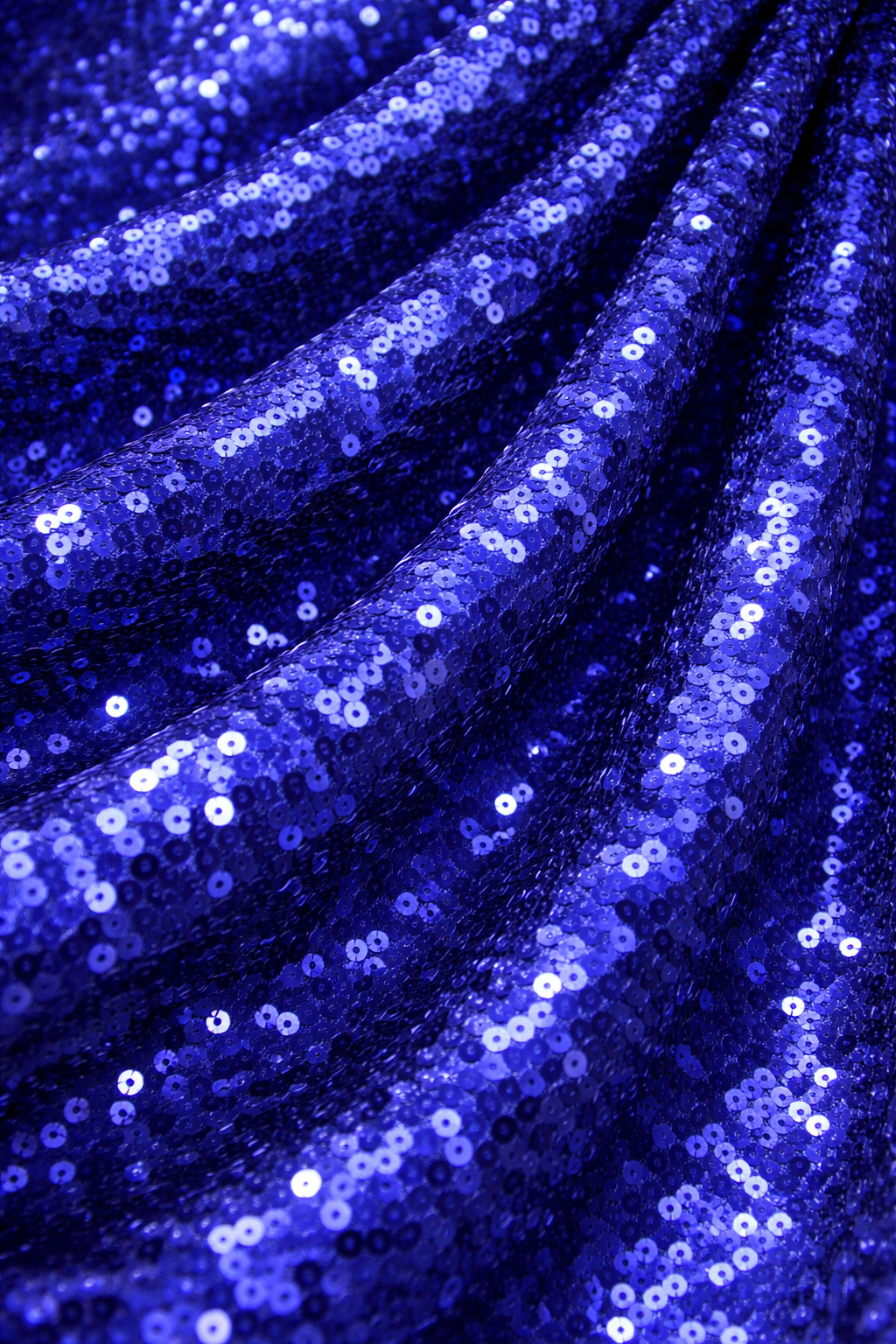 Close-up of blue sequin fabric with a sparkling texture for hire 7skyrent