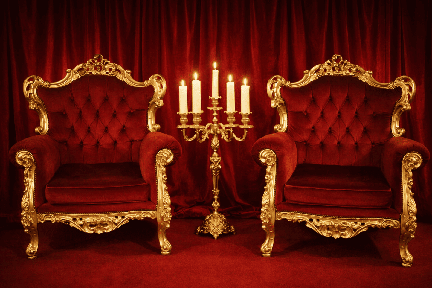 Ornate royal throne armchair with gold carved frame and red velvet fabric for photo shoot, film set and event lounge.